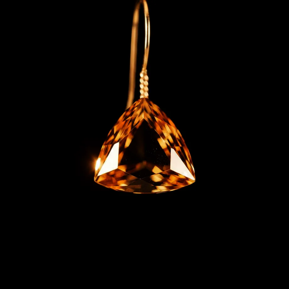 The Earring: a topaz tetrahedron hanging from a thin gold wire